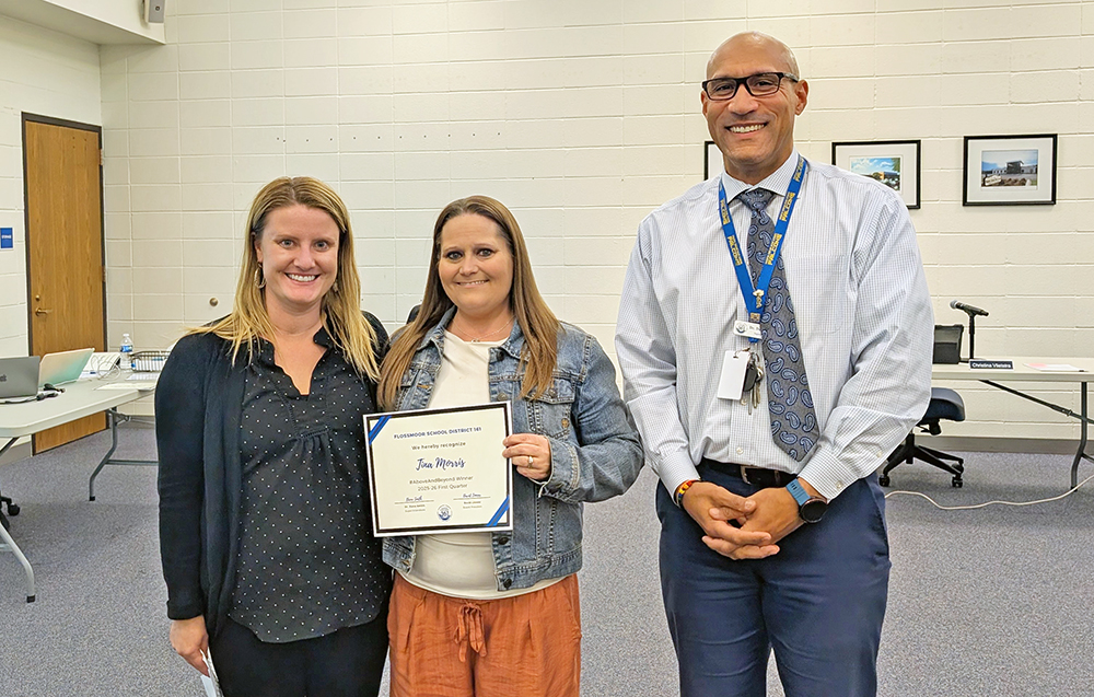 From left, Molly Woods, #AboveAndBeyond Award winner Tina Morris and Superintendent Dana Smith at the Oct. 27 board of education meeting. (Chris Weber/H-F Chronicle)