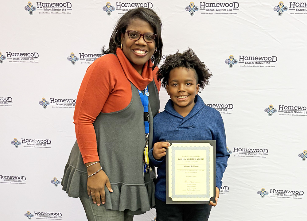 Churchill Principal Tara Peacock congratulated fifth grader Michael Williams, the school's Dockweiler honoree. (Marilyn Thomas/H-F Chronicle)