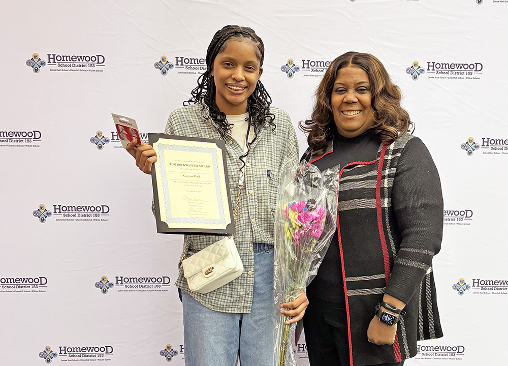 James Hart School Principal Kim Johnson offers congratulations to eighth grader Gavynn Hall on winning the Dockweiler honor. (Marilyn Thomas/H-F Chronicle)