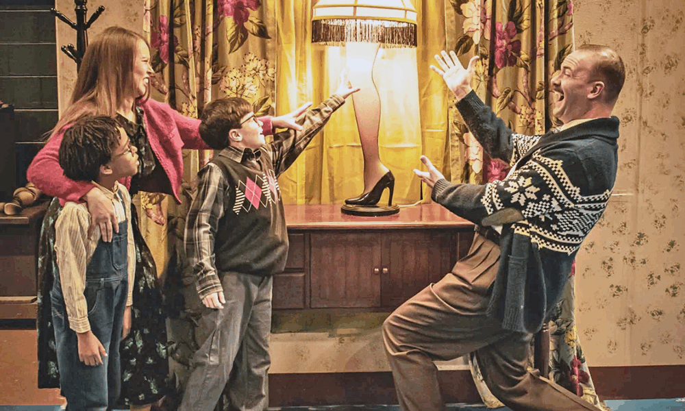 Members of "A Christmas Story" case act out the scene where The Old Man shows off his major award. In the scene, the mother is played by Crystal Phillips-Pierce, with son Randy performed by Aegis Rah'man, and Ralphie by Everett Johnson. The Old Man is played by Bob Bullen. (Provided photo/Stacey Froeschle)