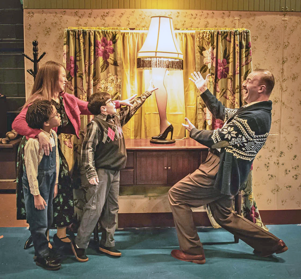 Members of "A Christmas Story" case act out the scene where The Old Man shows off his major award. In the scene, the mother is played by Crystal Phillips-Pierce, with son Randy performed by Aegis Rah'man, and Ralphie by Everett Johnson. The Old Man is played by Bob Bullen. (Provided photo/Stacey Froeschle)