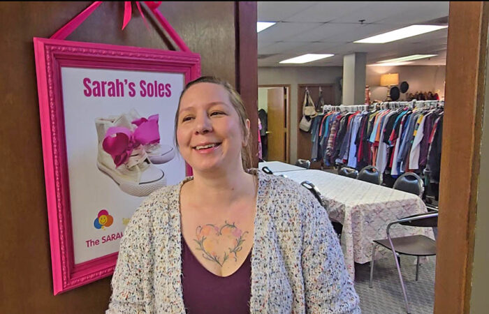 Kristen Ryan talks about her daughter, Sarah, prior to the ribbon cutting ceremony to dedicate the Suburban Access Outreach shoe store named for her. (Eric Crump/H-F Chronicle)