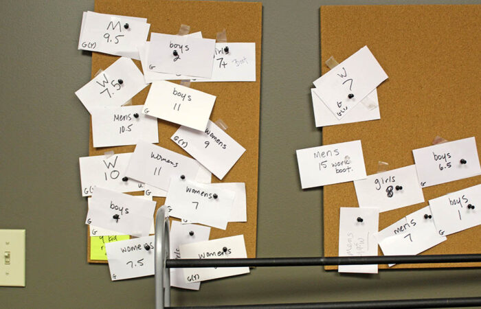 Shoe sizes fill a board inside Sarah’s Soles room. Staff add a new card each time a family or partner organization requests a specific size. (Nuha Abdessalam/H-F Chronicle)