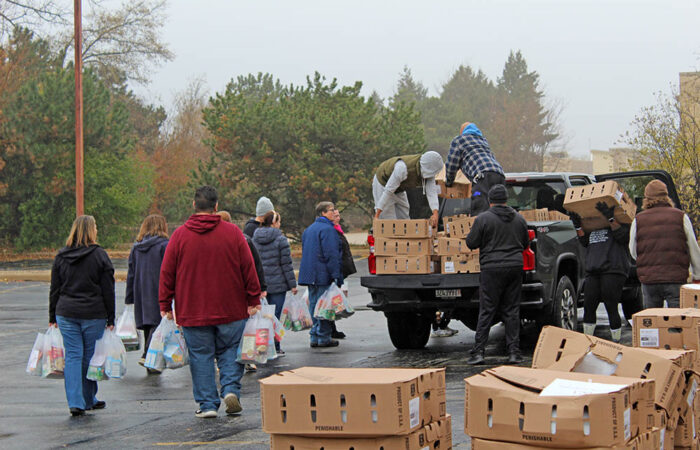 Suburban Access delivers 1,000 Thanksgiving meals amid rising need#5_web Volunteers carry Thanksgiving meal bags across the lot as distribution hits its morning peak during the annual Suburban Access Outreach Thanksgiving meal project. (Nuha Abdessalam/H-F Chronicle)