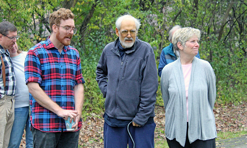 Emmett Houlihan speaks to the group as Tom and Patty Houlihan stand with him during the ceremony. (Nuha Abdessalam/H-F Chronicle)