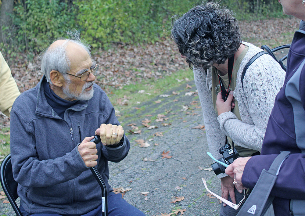 Former H-F Chronicle editor and pawpaw enthusiast Tom Houlihan, left, speaks with Flossmoor Communications Manager Nicole Castagna at the new pawpaw grove. (Nuha Abdessalam/H-F Chronicle)