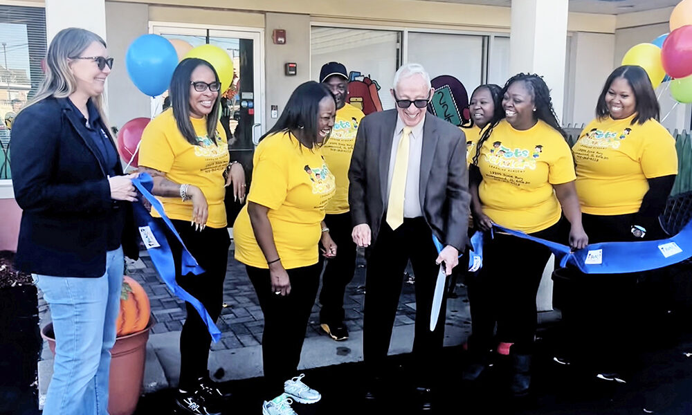 Homewood Mayor Rich Hofeld cuts the blue ribbon with Tots to Scholars ownership and staff. (Nick Ulanowski/ H-F Chronicle)