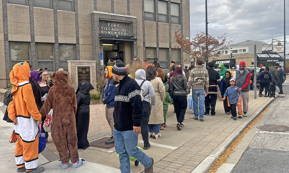 Trick-or-treaters lining up in front of the Homewood Fire station. (Nick Ulanowski / H-F Chronicle)