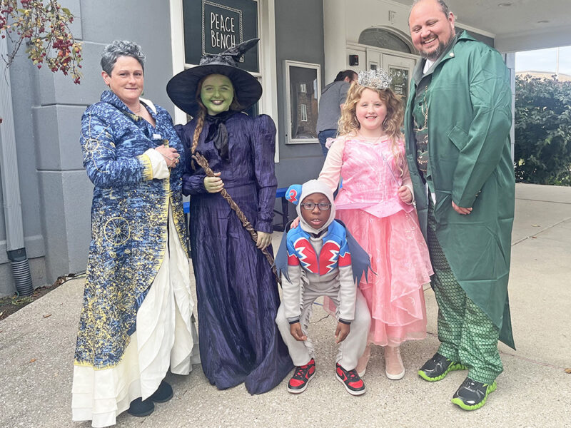 Amanda Pahlas, far left, Grier Pahlas, Ian Dukes, Finnlay Pahlas and Summit Pahlas trick or treat dressed like characters from the Broadway musical Wicked. (Nick Ulanowski / H-F Chronicle)