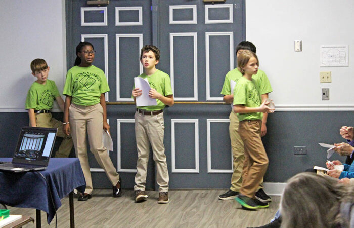 Members of the HF Robotics Cricketeers gather near the back of the room as they get ready to present their research on the Horton Site. (Nuha Abdessalam/H-F Chronicle)