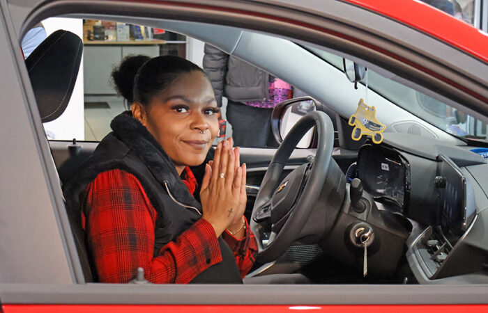 Christmas Eve- Chevy#12_web Lameisha Moon expresses gratitude for her new Chevrolet Trax from Chevrolet of Homewood. (Nuha Abdessalam/H-F Chronicle)