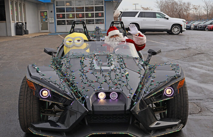 Christmas Eve- Chevy#1_web Santa Claus waves from a holiday-decorated Slingshot outside Chevrolet of Homewood during the dealership’s Christmas Eve giveaway event. (Nuha Abdessalam/H-F Chronicle)