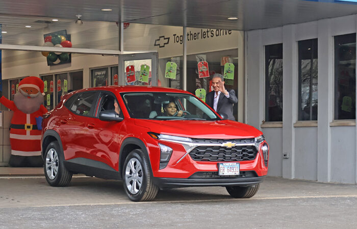 Christmas Eve- Chevy#8_web Lameisha Moon pulls her new 2026 Chevrolet Trax out of the Chevrolet of Homewood dealership as staff and onlookers watch on Christmas Eve. (Nuha Abdessalam/H-F Chronicle)