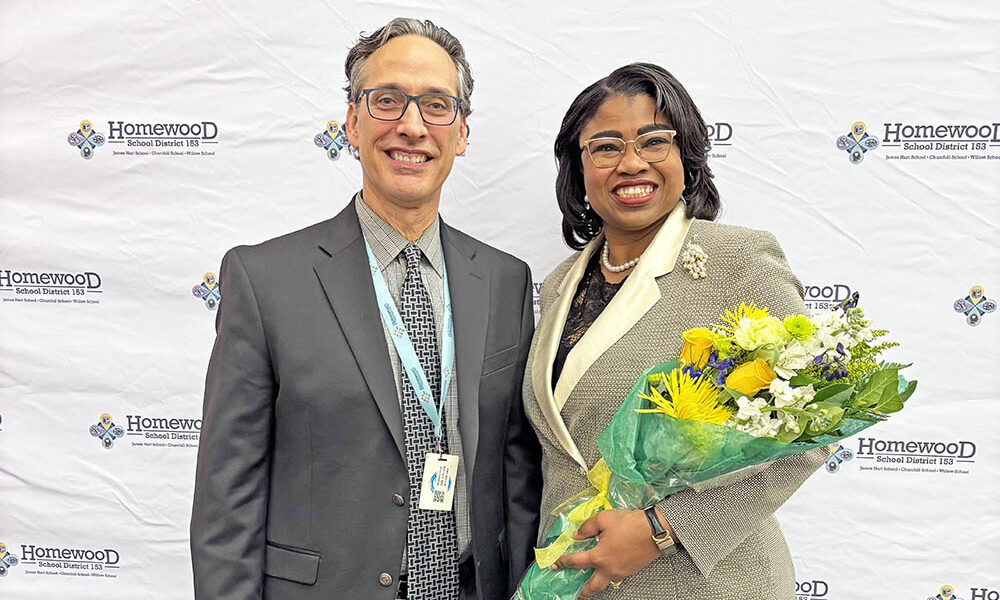 Outgoing District 153 Superintendent Scott McAlister, left, welcomes Teresa Hill, who was appointed by the school board Dec. 2 as its next superintendent starting July 1. (Marilyn Thomas/H-F Chronicle)