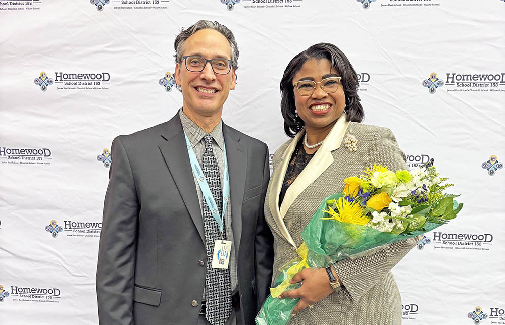 Outgoing District 153 Superintendent Scott McAlister, left, welcomes Teresa Hill, who was appointed by the school board Dec. 2 as its next superintendent starting July 1. (Marilyn Thomas/H-F Chronicle)
