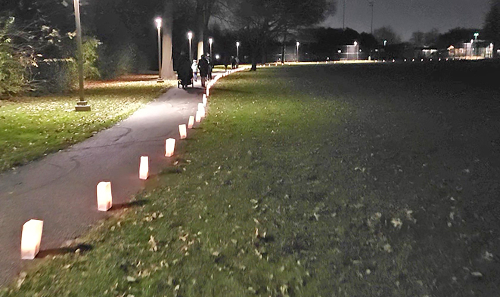 Flossmoor Service League luminaries shine along the trail in Flossmoor Park during the village's 2023 Celebrate the Season winter festival. Luminary sales are one of the ways FSL raises money to help local charity organizations. (Chronicle file photo)