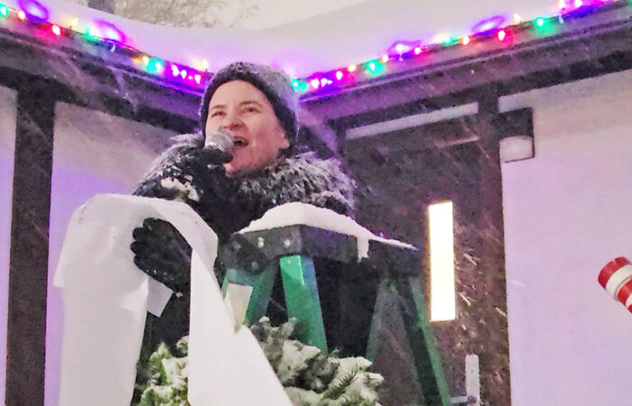 Flossmoor Mayor Michelle Nelson reads from her extensive "nice list," thanking village staff and volunteers who helped make the holiday celebration possible. (Eric Crump/H-F Chronicle)