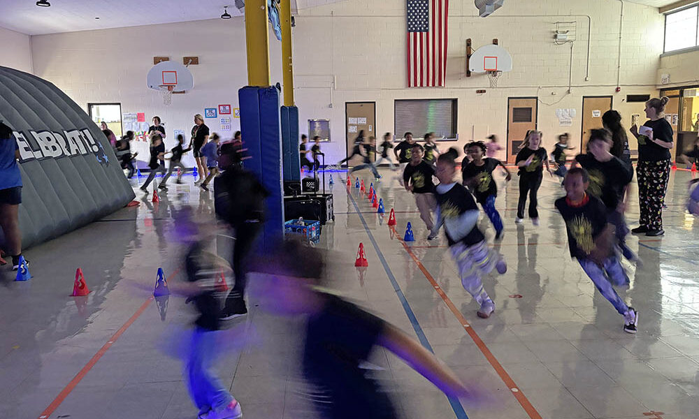 The Willow School gym became a running course as students ran around in the Glow Run fundraiser Friday, Nov. 21. (Marilyn Thomas/H-F Chronicle)