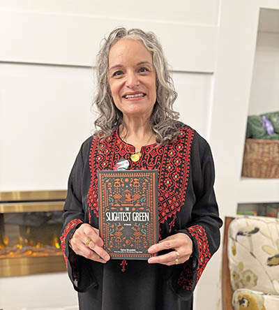 Sahar Mustafah, a creative writing teacher at Homewood-Flossmoor High School, displays her latest novel "The Slightest Green" during a book reading at Beyond Books in Homewood on Nov. 20. (Marilyn Thomas/H-F Chronicle)