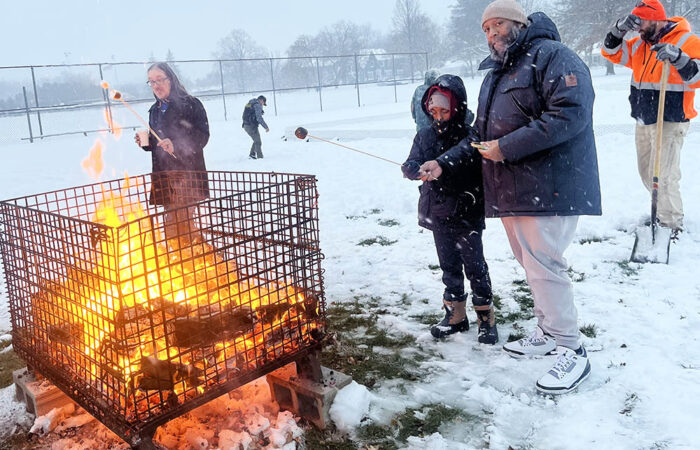 Dorian Davis and his son, Jaxson Davis, roasts marshmallows in the bonfire. (Nick Ulanowski / H-F Chronicle)