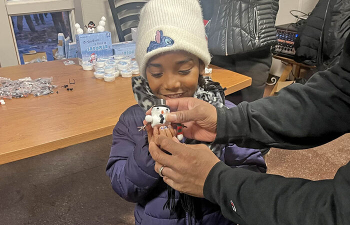 Aria Neal, a 6-year-old Homewood resident, shows off the holiday ornament ahead she made. (Nick Ulanowski / H-F Chronicle)