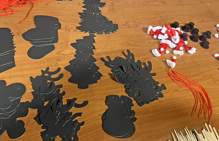 Supplies on the crafts table for making holiday tree ornaments. (Nick Ulanowski / H-F Chronicle)