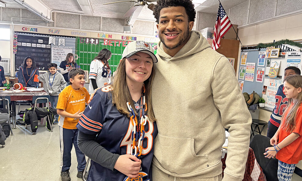 Churchill School teacher Hannah Henson meets Bears Linebacker D'Marco Jackson. Henson's class has been corresponding with Jackson this season. (Marilyn Thomas/H-F Chronicle)