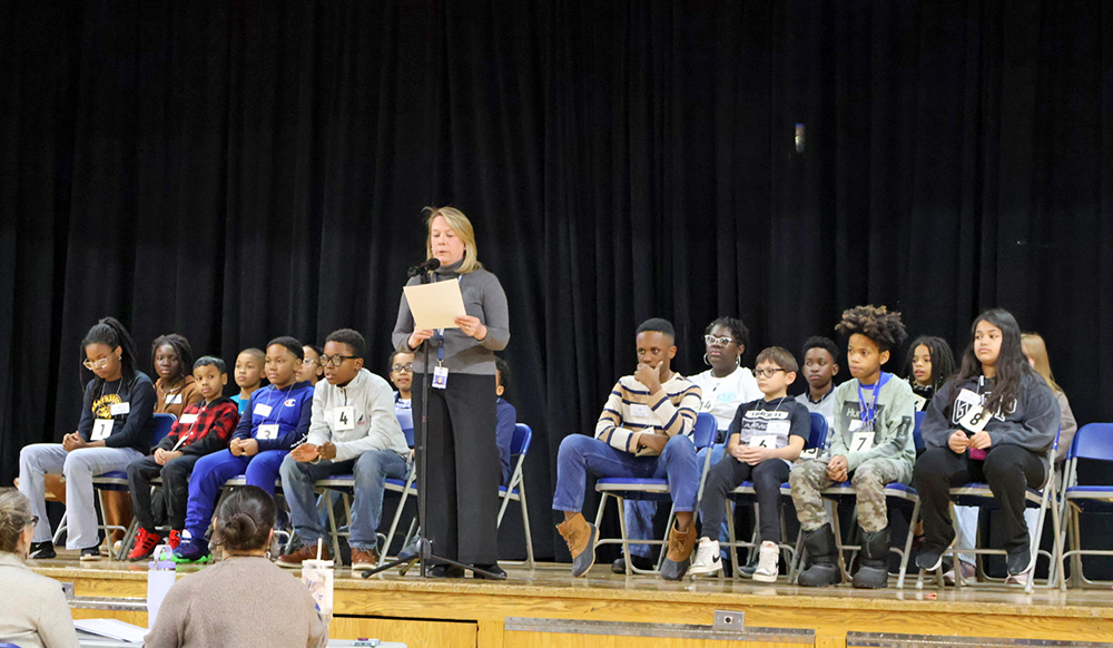 Sandy Thompson, the Academic Center for Enrichment (ACE) teacher at Flossmoor Hills Elementary School, addresses students during the spelling bee she has helped lead for years. (Nuha Abdessalam/H-F Chronicle)