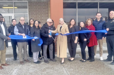 Mayor Rich Hofeld holds the scissors while standing next to Face2Face Maxillofacial Surgery Centre owner Robin Gallardi, right, surrounded by other staff snd village official. (Nick Ulanowski H-F Chronicle)