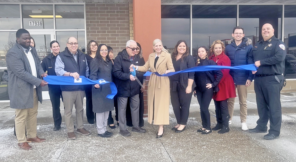 Mayor Rich Hofeld holds the scissors while standing next to Face2Face Maxillofacial Surgery Centre owner Robin Gallardi, right, surrounded by other staff snd village official. (Nick Ulanowski H-F Chronicle)