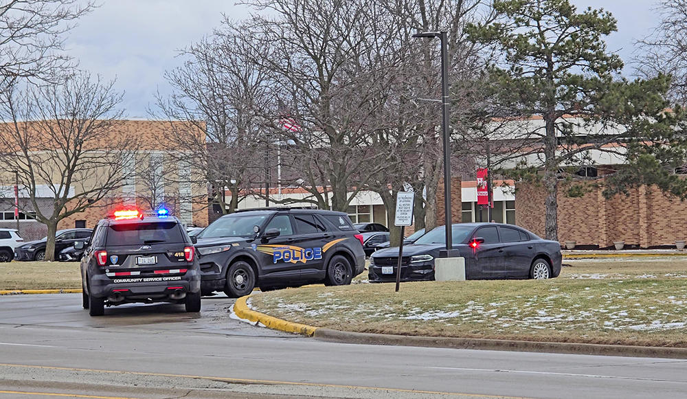 Police vehicles are stationed at Homewood-Flossmoor High School on Friday afternoon, Jan. 16, after a gun was found in the South Building. (Eric Crump/H-F Chronicle)