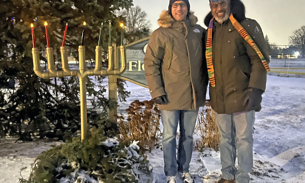 Flossmoor School District 161 Superintendent Dana Smith, left, and Flossmoor School District 161 school board President David Linnear after lighting the Kinara on Dec. 29, the fourth day of Kwanzaa. (Nick Ulanowski / H-F Chronicle)