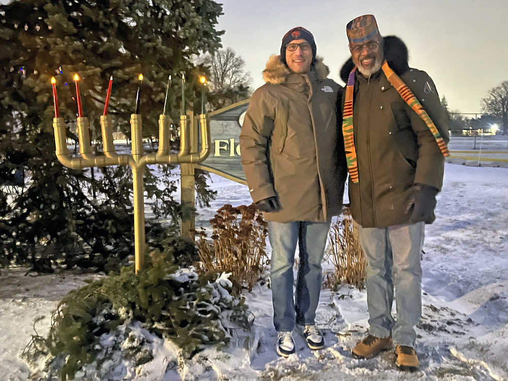 Flossmoor School District 161 Superintendent Dana Smith, left, and Flossmoor School District 161 school board President David Linnear after lighting the Kinara on Dec. 29, the fourth day of Kwanzaa. (Nick Ulanowski / H-F Chronicle)