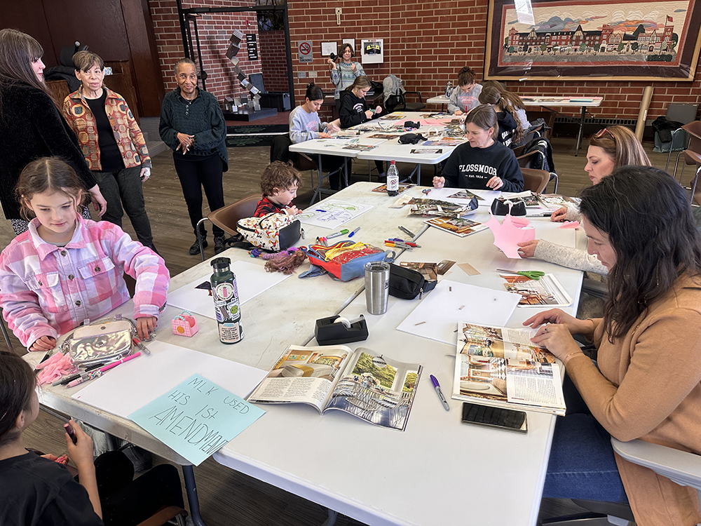 From left, Rose Price and her brother Simon Price work on their yards signs with the help of Mayor Michelle Nelson, Angella Jost and their mother, Beth Price. (Jon Bannister/H-F Chronicle)