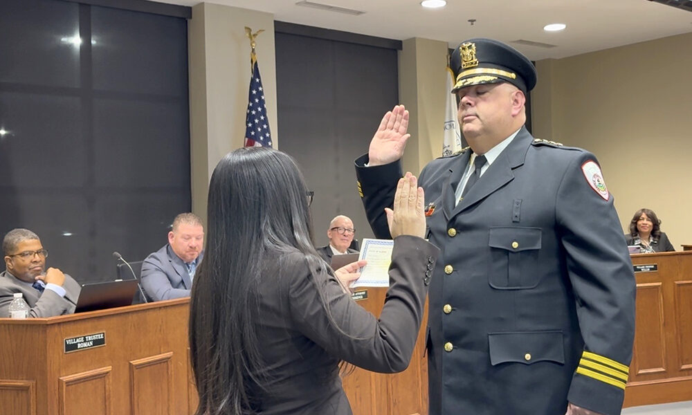 Thomas Johnson taking the oath of office for his new position as Homewood chief of police at the Jan. 27 village board meeting. (Summer Kiswani/ H-F Chronicle)