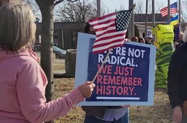 A participant at the ABT Presidents Day rally in Homewood holds a sign that reads, "We're not radical. We just remember history." (Eric Crump/H-F Chronicle)