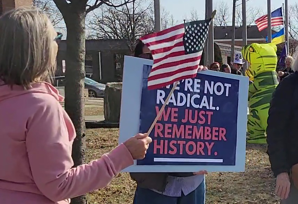 A participant at the ABT Presidents Day rally in Homewood holds a sign that reads, "We're not radical. We just remember history." (Eric Crump/H-F Chronicle)