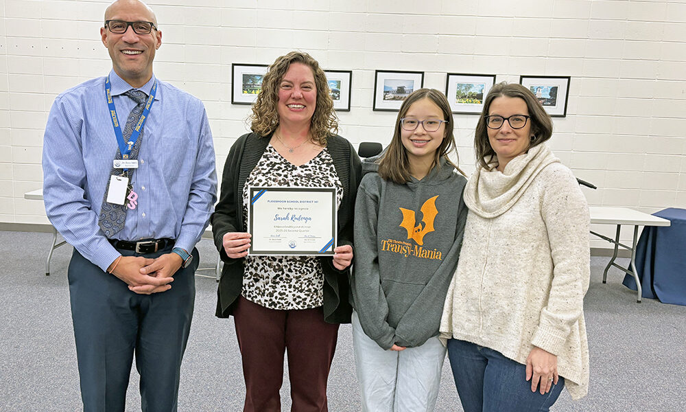 District 161 Superintendent Dana Smith, joins seventh grader Avery Cheung and her mom Karen, at right, in congratulating Sarah Rudenga, media center coordinator at Parker Junior High, on her receiving the #Aboveandbeyond honor. (Marilyn Thomas/H-F Chronicle)