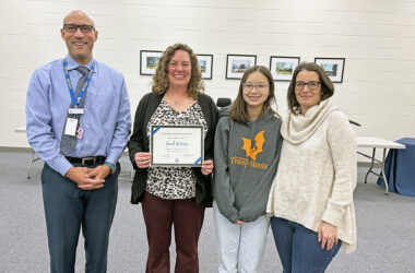 District 161 Superintendent Dana Smith, joins seventh grader Avery Cheung and her mom Karen, at right, in congratulating Sarah Rudenga, media center coordinator at Parker Junior High, on her receiving the #Aboveandbeyond honor. (Marilyn Thomas/H-F Chronicle)