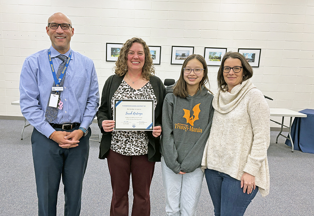 District 161 Superintendent Dana Smith, joins seventh grader Avery Cheung and her mom Karen, at right, in congratulating Sarah Rudenga, media center coordinator at Parker Junior High, on her receiving the #Aboveandbeyond honor. (Marilyn Thomas/H-F Chronicle)