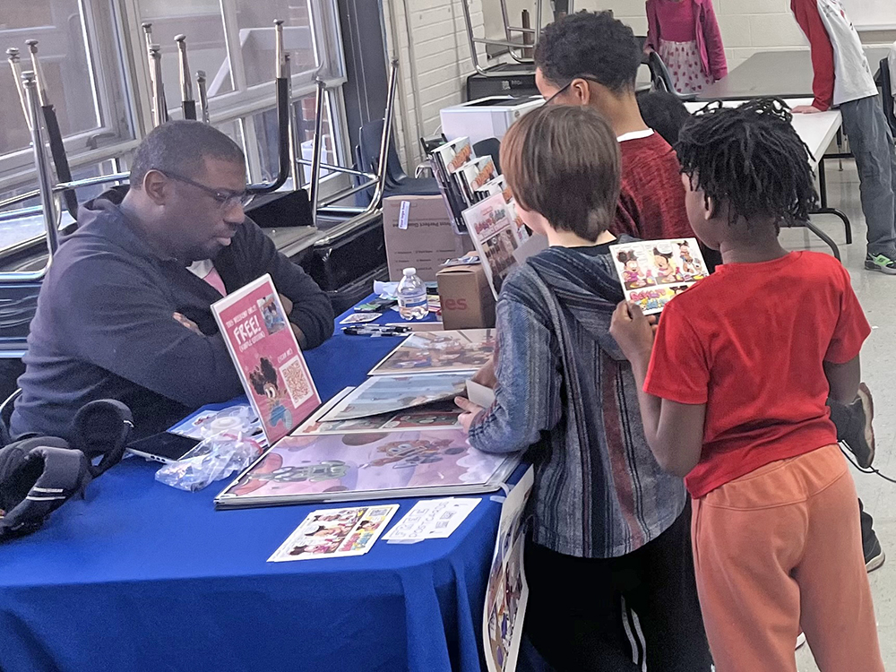 Kids lining up to meet comic strip artist George Gant at the Black History Month Book Fair. (Photo by Nick Ulanowski)