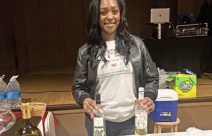 CFFEIM client success manager Nadja Sowell serves drinks to attendees at Soup's on for Equity fundraiser. (Nick Ulanowski / H-F Chronicle)