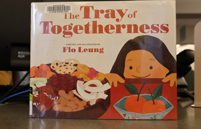 A copy of "The Tray of Togetherness" by Flo Leung, the book read during story time at Flossmoor Public Library’s Lunar New Year celebration. (Nuha Abdessalam/H-F Chronicle)