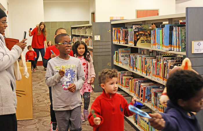 Children and families move through the second floor during the Lunar New Year parade at Flossmoor Public Library. (Nuha Abdessalam/H-F Chronicle)