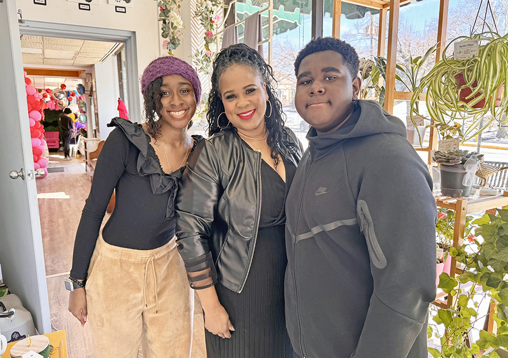 Kellie Lucas of Flossmoor is joined by her daughter Kaleigh (left) and son Aidan next to the living window display Lucas created at Gypsy Fix. (Karen Torme Olson/H-F Chronicle)