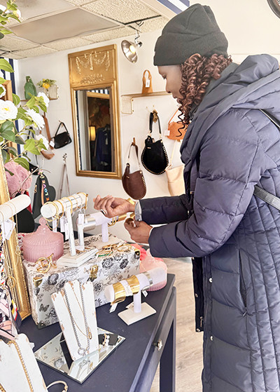 Monique Turner of Flossmoor examines new jewelry items on display at Gypsy Fix. (Karen Torme Olson/H-F Chronicle)