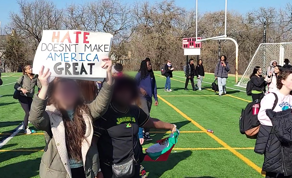 A student carries a sign that says "Hate doesn't make America great" at the anti-ICE protest on Friday, Feb. 13, at Homewood-Flossmoor High School. (Eric Crump/H-F Chronicle)