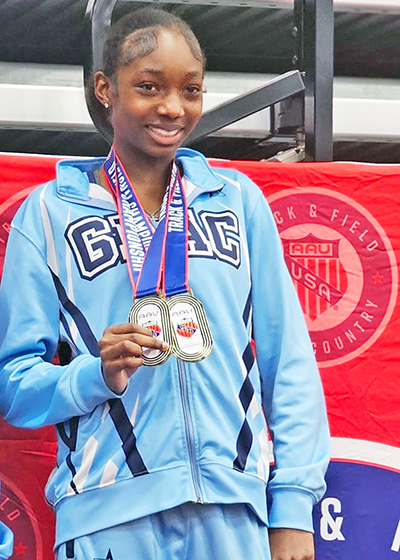 Nia Branham, an eighth grader at James Hart School, shows off two of her AAU meet medals. Her favorite races are the 200-meter and the 400-meter. (Provided photo)