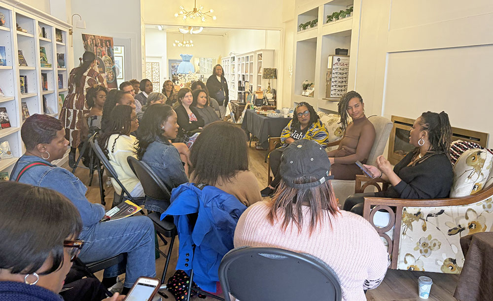 Event speakers talk to attendees at the Becoming Change Makers book signing and women's event at Beyond the Book on March 7. (Jamilah Lewis/H-F Chronicle)