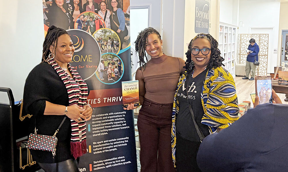 From left, Shemeka Woodson, Dominica McBride and Keisha Farmer-Smith pose for a photo in front of the BECOME banner at the Becoming Change Makers Book signing and women's event at Beyond the Book on Saturday, March 7. (Jamilah Lewis/H-F Chronicle)